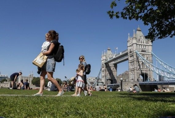 People walk at Potters Fields Park in front of the Tower Bridge in London, Britain, June 1, 2021. (Xinhua/Han Yan/IANS)